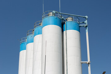 tall factory barrels and blue sky