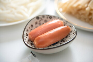 Two hams on a small plate.