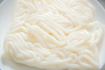 Wet rice noodles in a bowl.