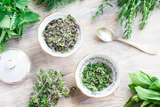 Fresh and dried herbs, lieves mix on wood table