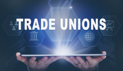 Businessman holding a computer tablet display projecting a Trade Unions concept.