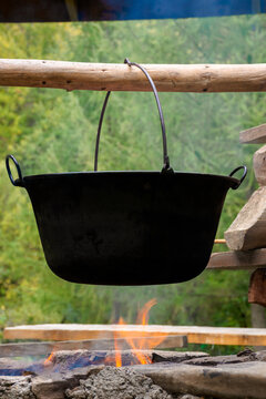 traditional hungarian bogracs goulash soup. cooking dish on open fire in a cauldron. preparing healthy food outdoors concept. popular european cuisine