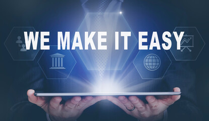 Businessman holding a computer tablet display projecting a We Make It Easy concept.
