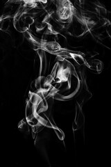 White puffed smoke in a dark background