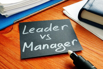 Leader vs manager is shown on the conceptual business photo