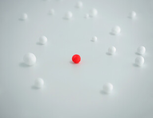 A scattering of white and red foam balls on a white background, short focus