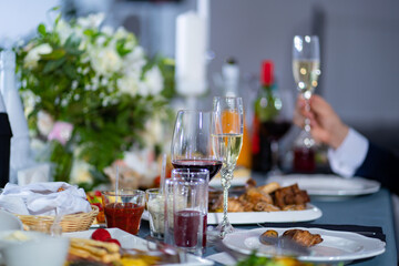 glasses on table during Banquet. on background blurred hand with champagne.