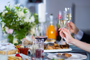 glasses with drinks on table during Banquet in hand of the bride and groom.