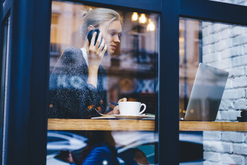 Woman in cafe talking phone