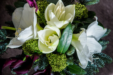 top view closeup on white and cream lily, purple calla flowers and fresh greenery