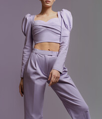 fashionable young woman in puffy sleeves light purple top pants suit