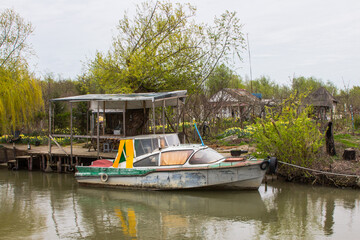 Fototapeta na wymiar Motorboat in the Ukrainian city of Vilkovo. The city was built in the Danube Delta. People move on the water in boats.