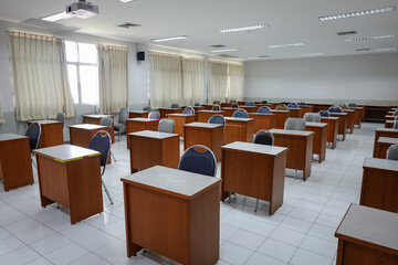Empty classroom with vintage tone wooden chairs. Classroom arrangement in social distancing concept to prevent COVID-19 pandemic. Back to school concept....