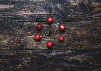 creative background of cherries on wooden background