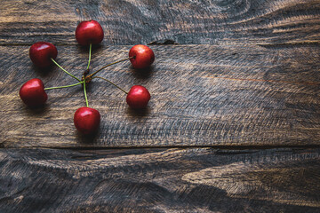 creative background of cherries on wooden background