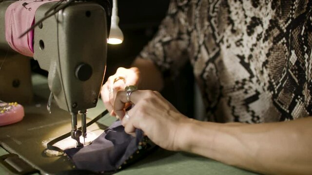 Fashion Designer working in his shop creating protective masks. Small business creative at work. Diversity and authentic artisan. Shot in 4k and in slow-motion.