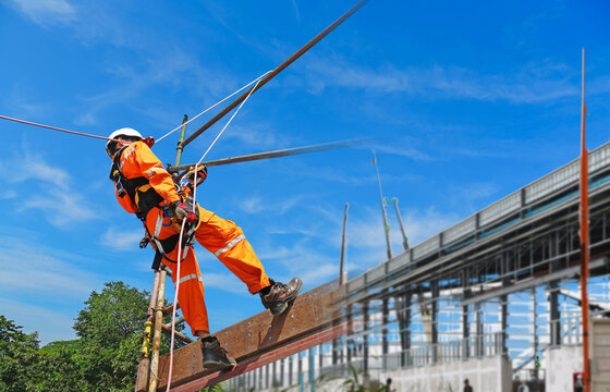 workers wearing equipment protective safety harness with rope access in construction site