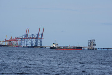 The oil tanker in the back is the harbor crane