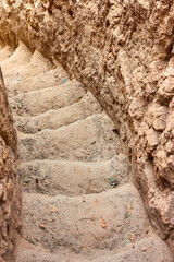 Staircase, carved in clay crag. Steep climb up srairs carved in cliff of loamy soil.