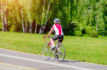 Fototapeta na wymiar Cyclist ride on the bike path in the city Park