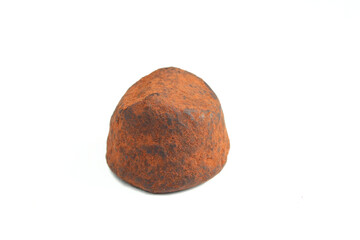 Belgian chocolate truffle isolated on white background. Cocoa dusted dessert