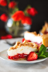 Slice of delicious strawberry tart with meringue on wooden background. Summer food