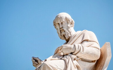 Fototapeta premium Plato the ancient Greek philosopher white marble statue on sky background, Athens Greece