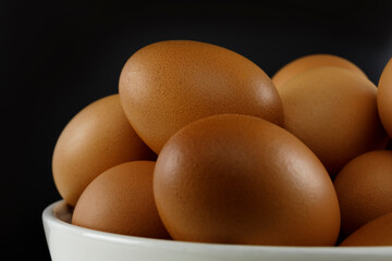 Close up fresh chicken eggs on linen tablecloth and white table with copy space .