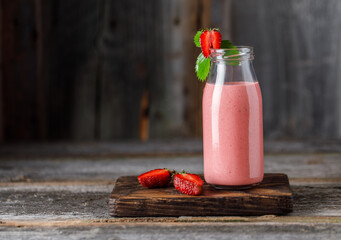 Strawberry milkshake in the glass jar.  Strawberry smoothie, healthy food for breakfast and snack