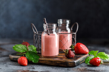 Strawberry milkshake in the glass jar.  Strawberry smoothie, healthy food for breakfast and snack