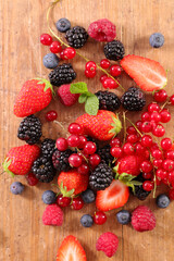assorted of fresh berries fruits on wood background