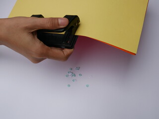 Woman Using Black Steel Hole Puncher Isolated On White Background.