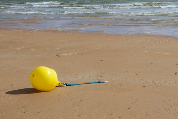 Bouée jaune sur la plage