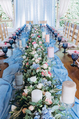 Candles on the table.Flower decoration of wedding tables.
Banquet table setting and decoration. 