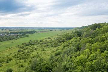 Fototapeta na wymiar green hills near the city of Gorbatov