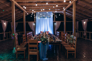 Banquet table setting and decoration. Cutlery on the table. Blue interior decoration.

