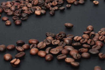 Coffee in beans on dark background. Coffee beans texture. Food background of coffee beans
