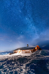 Mountain hut under the stars in the winter, Switzerland