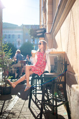 Little girl at outdoor cafe on warm summer day