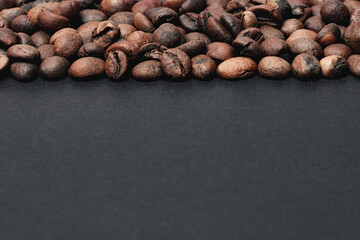 Coffee in beans on dark background. Coffee beans texture. Food background of coffee beans