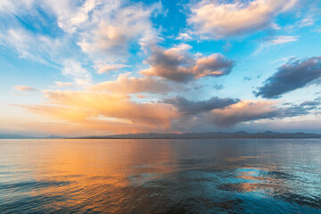 Naklejka na ściany i meble Beautiful sunrise on the lake with colorful clouds. Armenia Sevan lake