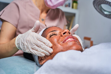 Beauty face skin care. Woman with cosmetic facial mask. Selective focus.