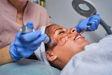 Beauty face skin care. Woman with cosmetic facial mask. Selective focus.