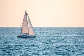 Sailing yacht in the blue calm sea.