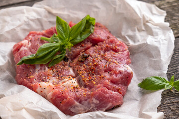 Raw pork neck meat with spices. Closeup