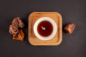 Sujeonggwa - Korean punch with cinnamon and dried persimmons. Dark reddish brown in color, it is...