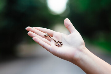 Hand with antique skeleton key. The key in a human hand. Old key in human hands.