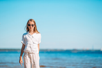 Young beautiful girl having fun on tropical seashore.