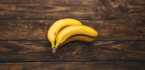 yellow bananas on wooden table