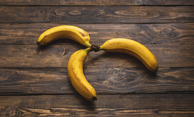 yellow bananas on wooden table